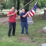 Br. Mo Krishna and W.B. Hal Cottrell putting up flags at Bellevue Cementary