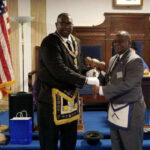 PH Deputy Grand Master Freddie Clopton presenting the gavel to WM Myron Bell of Bellevue Lodge No. 325.