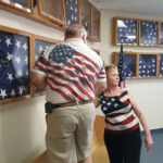 W.B. Wes Agar and Kim Hansen putting flags back in the display cases